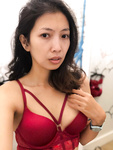 Tammy poses in a red bra