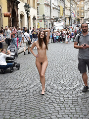 A young girl walks naked through the streets of Prague